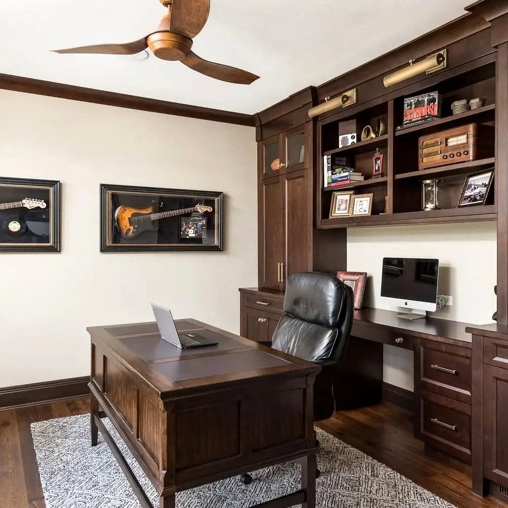A bold home office addition with dramatic charcoal walls and ceiling, built-in floating shelves with butcher block desk surface, matte black casement windows, and a sculptural gold globe chandelier. A sophisticated and functional Philadelphia home addition perfect for a dedicated work-from-home space.